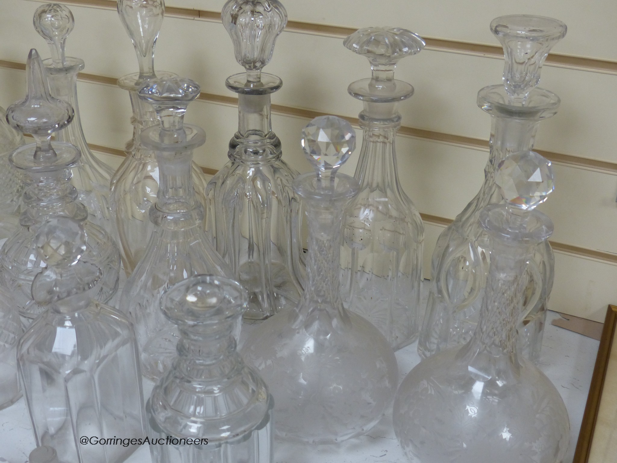 A collection of cut glass decanters, stoppers, etc.